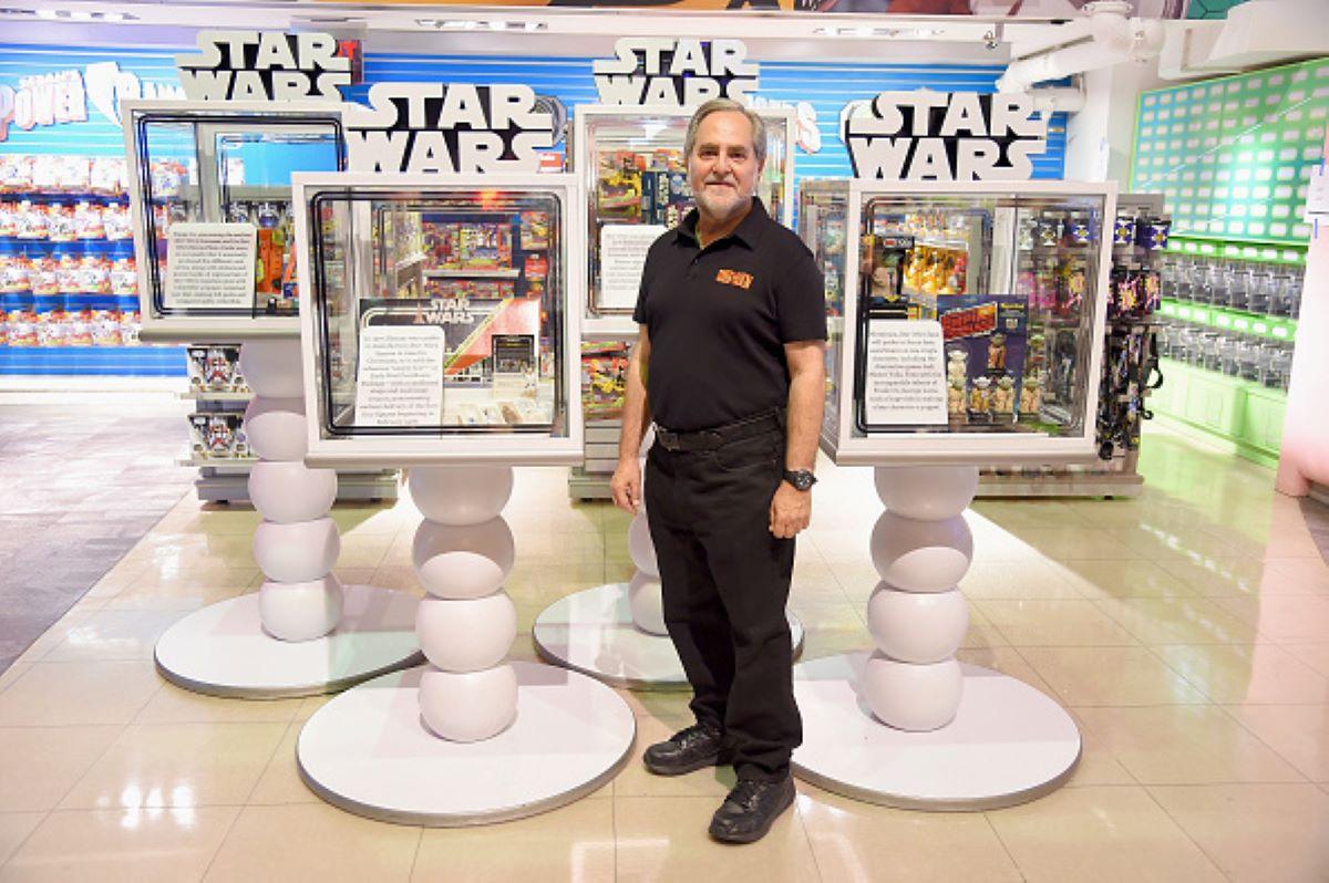 A man stands with Star Wars toys at an Out-of-this-Galaxy event