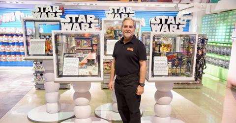 A man stands with Star Wars toys at an Out-of-this-Galaxy event