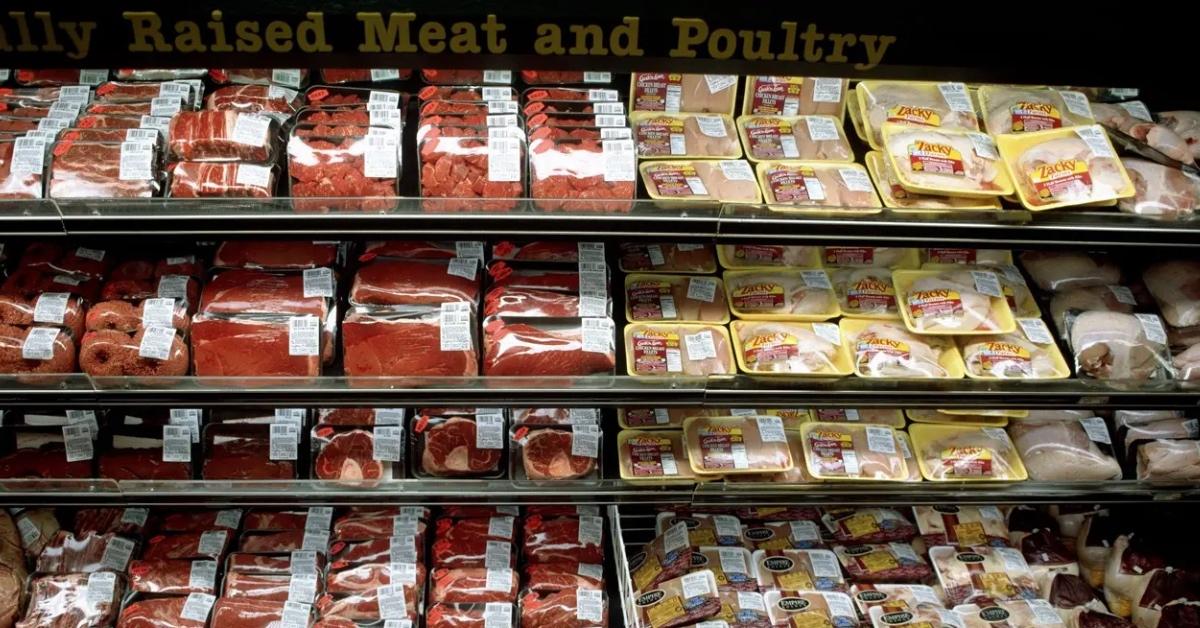 A selection of meat and chicken displayed in a grocery store.