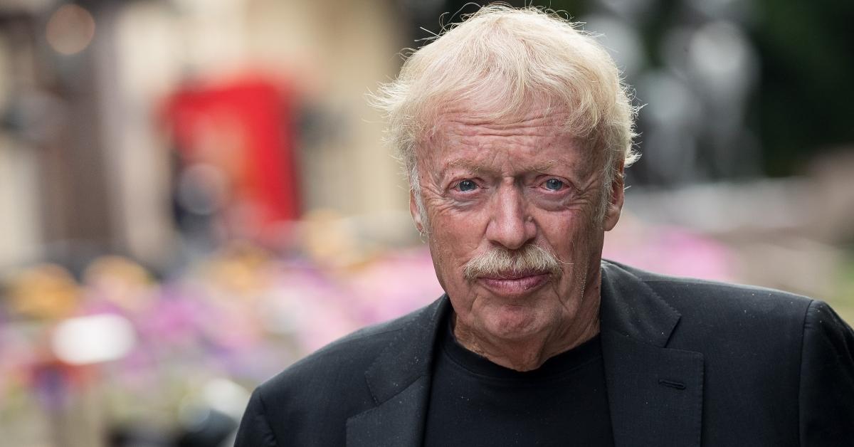 Phil Knight in a black sports coat and shirt
