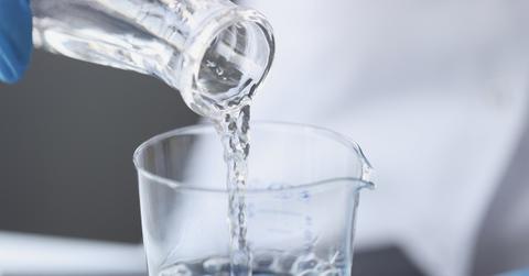 Scientist examines drinking water in laboratory closeup