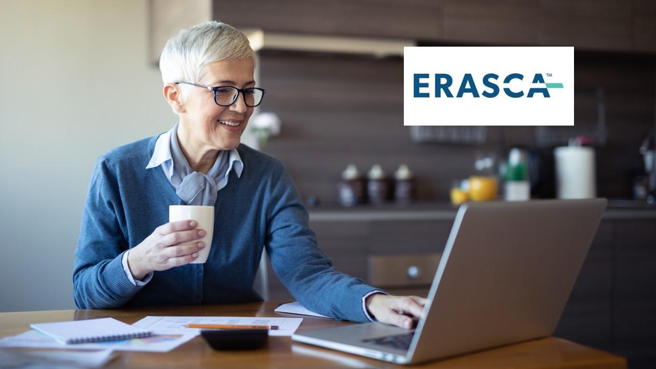 Woman looking on a laptop and Erasca logo