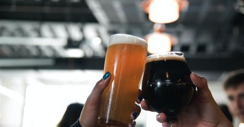 People doing a toast with beer mugs
