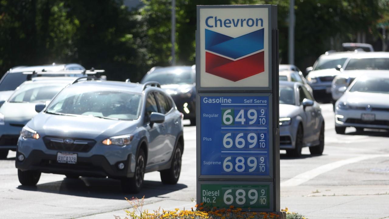 A Chevron sign with gas prices on it