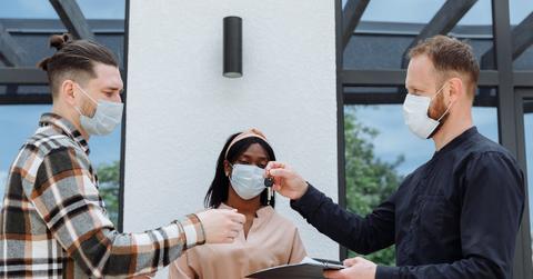 A real estate agent handing keys to a client