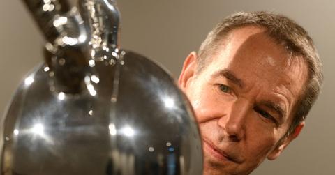 Jeff Koons looking at sculpture