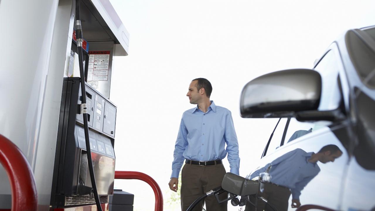 A man pumping gas