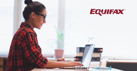 A woman typing on a laptop