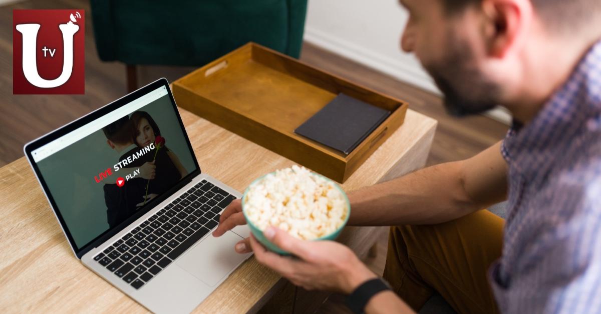 A man streaming a move on his computer.