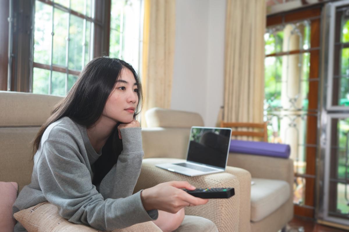 A woman watching TV from a free app