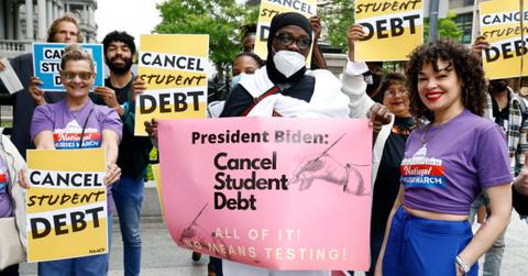Students holding loan forgiveness signs