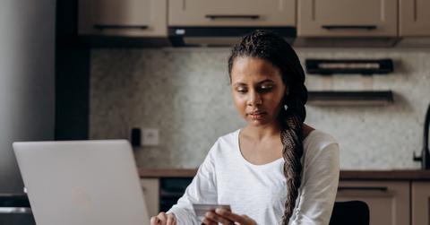 A person checking their credit score on a laptop