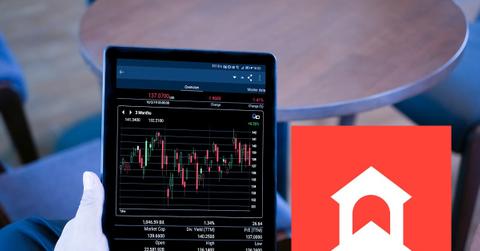 Person holding a tablet displaying crypto prices