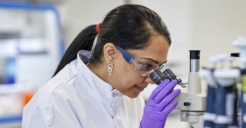GlaxoSmithKline scientist using a microscope