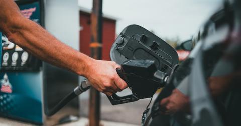 A man putting gas in a car