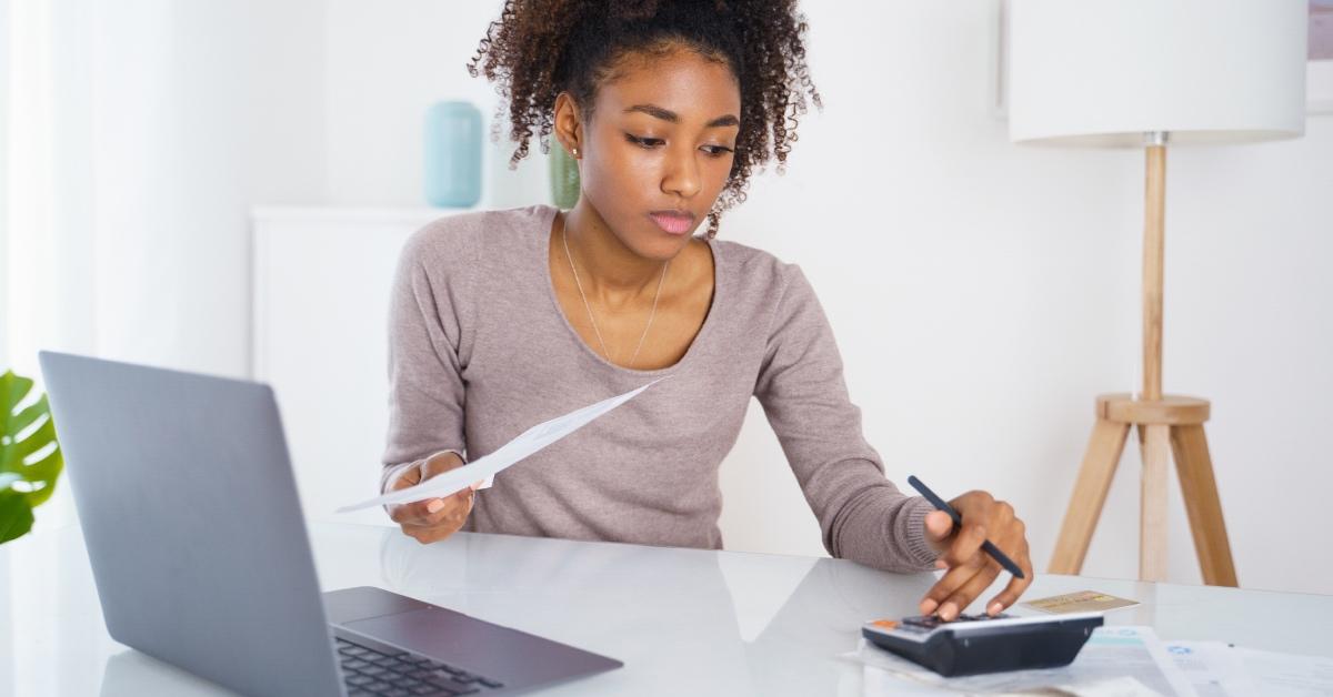 A girl calculating her student loan debt.