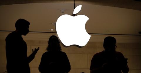 Apple employees with logo in background