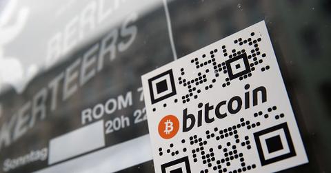 A sticker on the window of a local pub indicates the acceptance of Bitcoins for payment