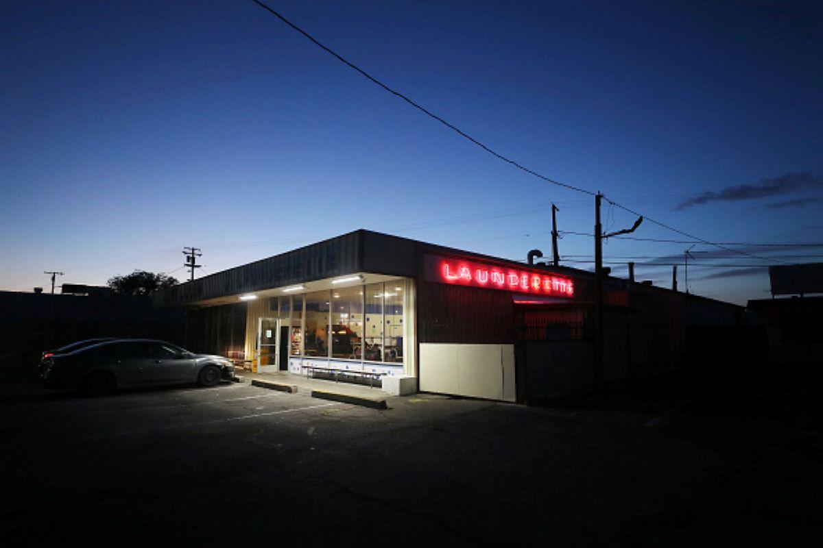 A laundromat lit at dusk along Route 66