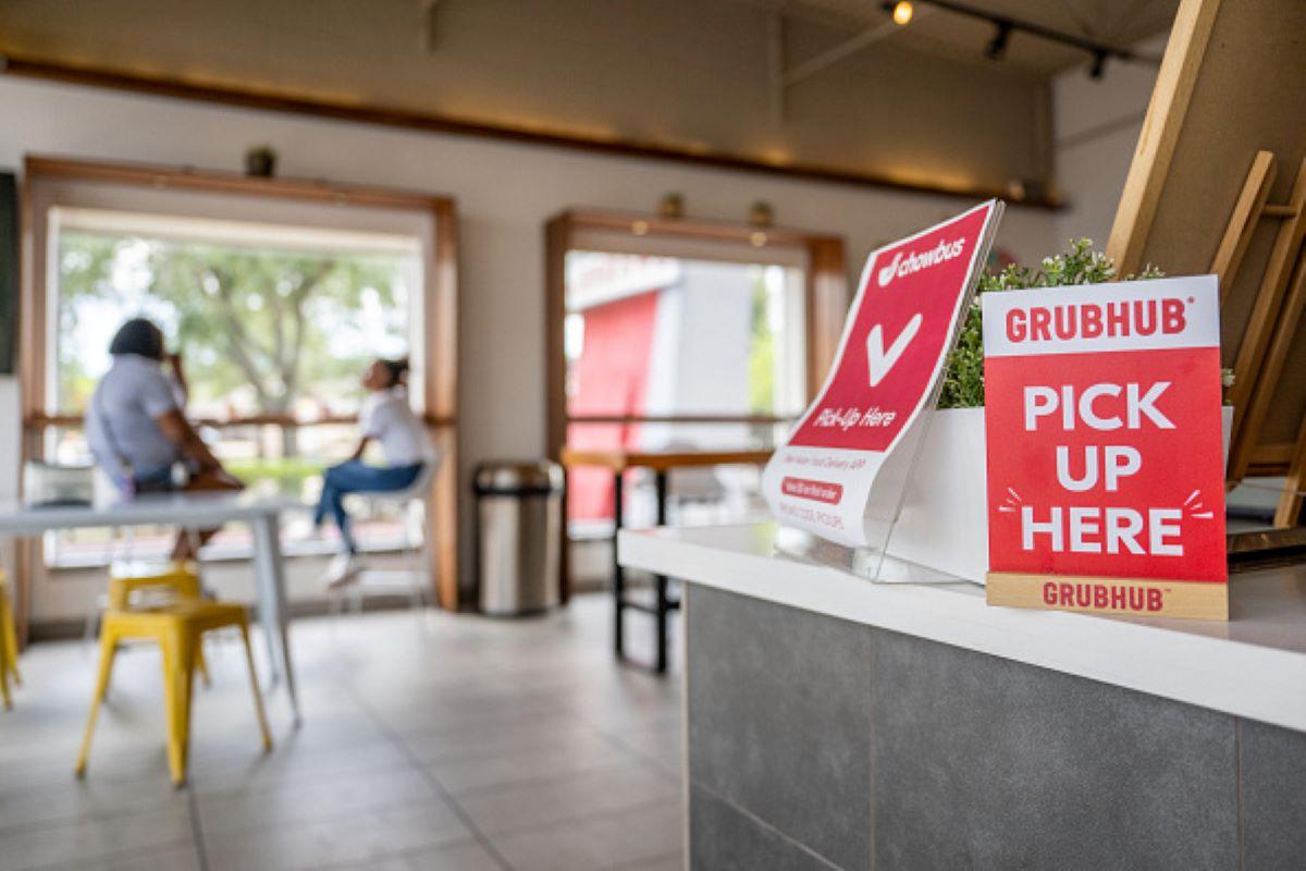 A GrubHub "Pick Up Here" sign at a restaurant