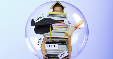 A person holding books and surrounded by IOU notes