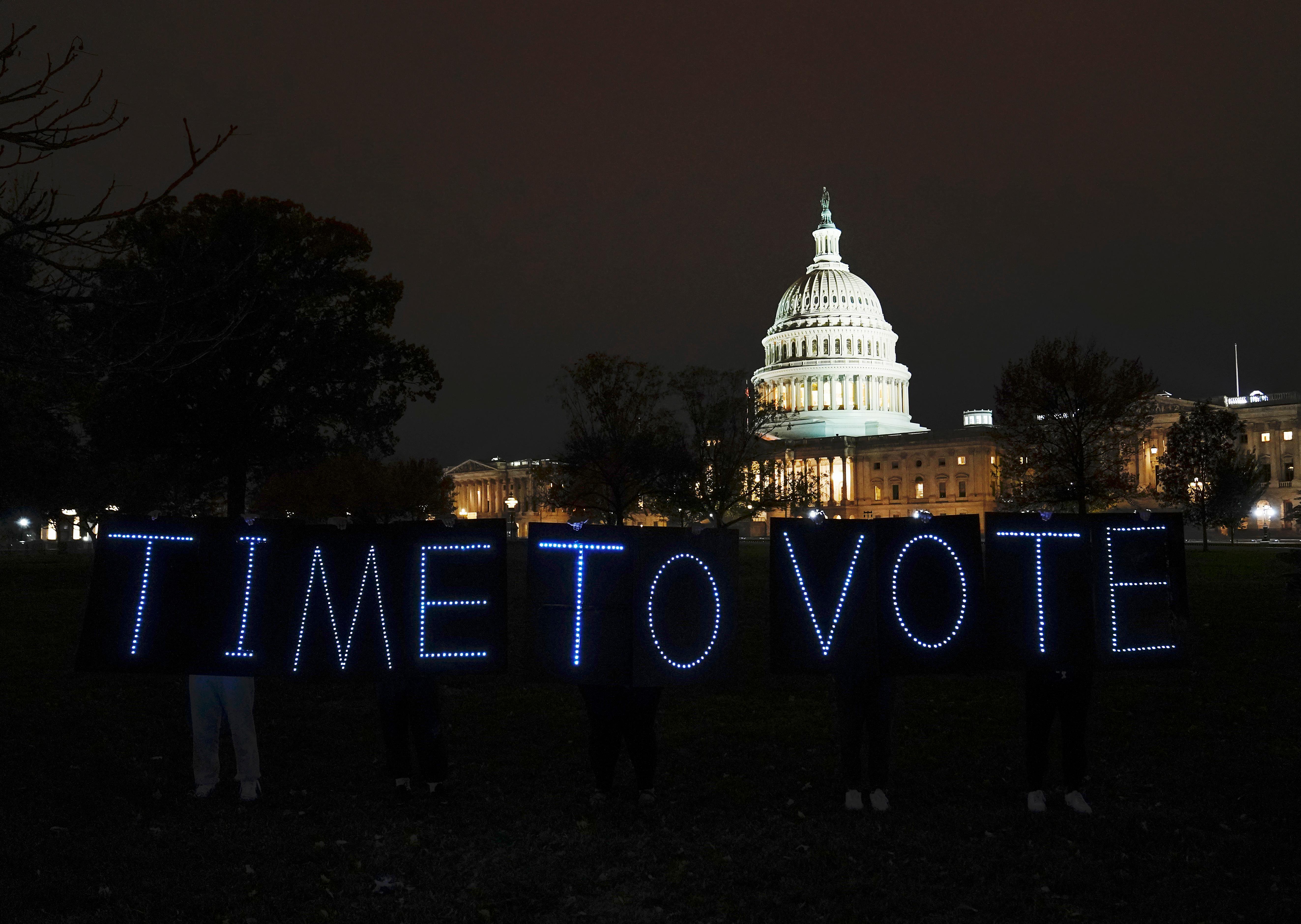 Time to Vote in lights outside of capitol building in awareness of social spending bill