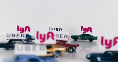 The ride-sharing wars! Uber and Lyft conceptual road concept using toy cars.