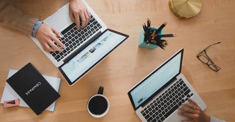 Two people looking at laptops