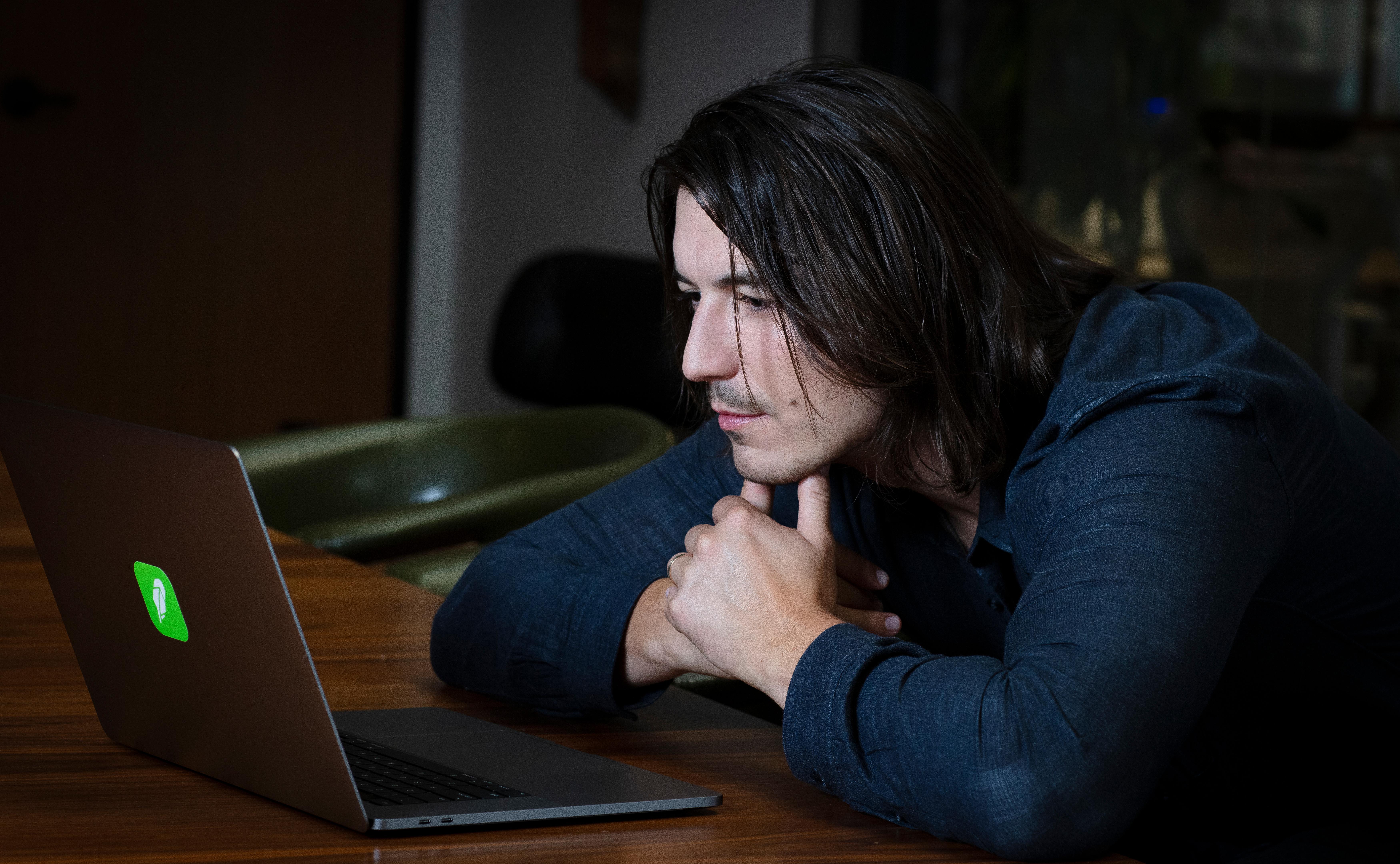 Robinhood CEO Vlad Tenev using a laptop