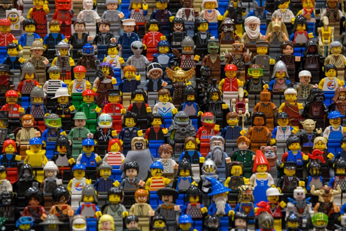 Dozens of little LEGO figures on display at a conference