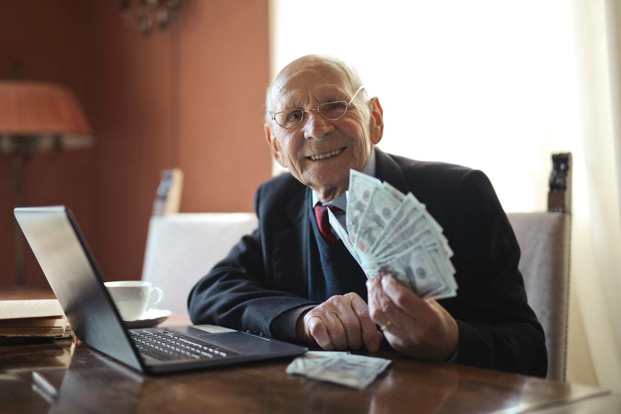 Senior businessman holding money in hand