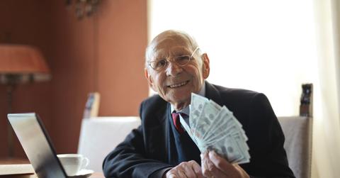 Senior businessman holding money in hand