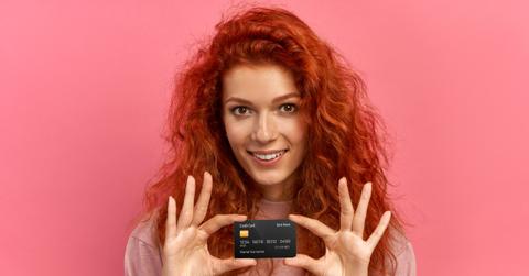 A woman holding her first credit card