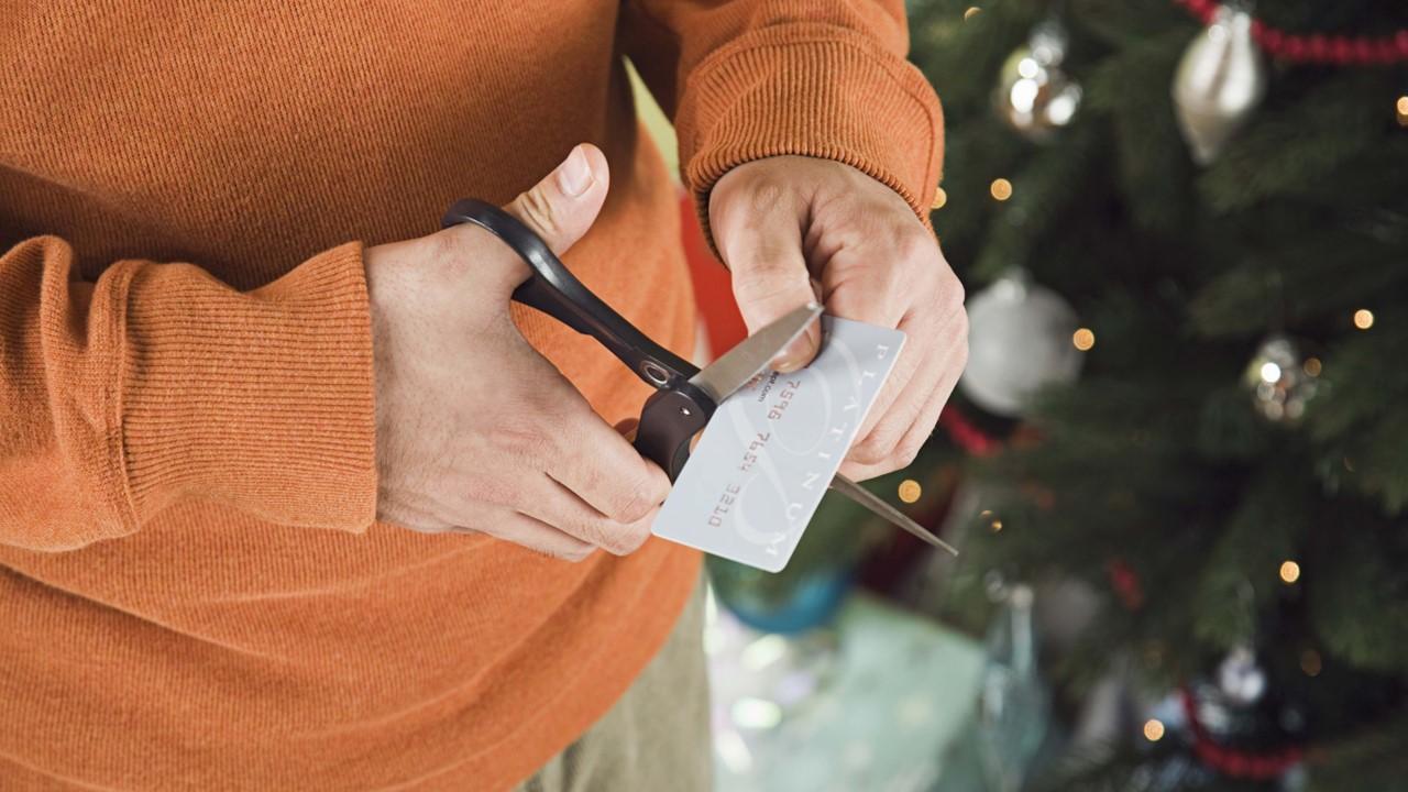 A man cutting up a credit card