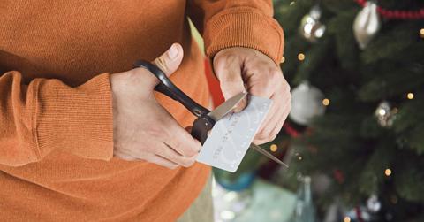 A man cutting up a credit card