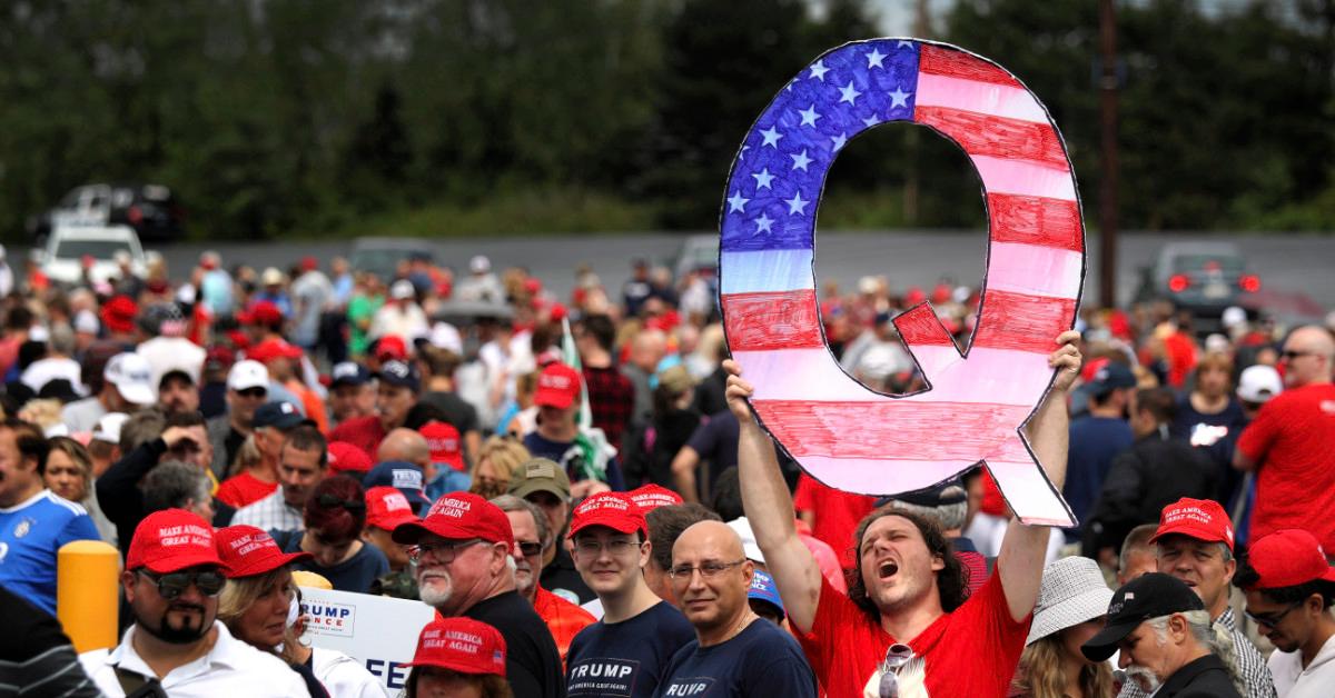 Man with Q sign at Trump rally