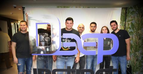 Deep Instinct company team members standing behind sign