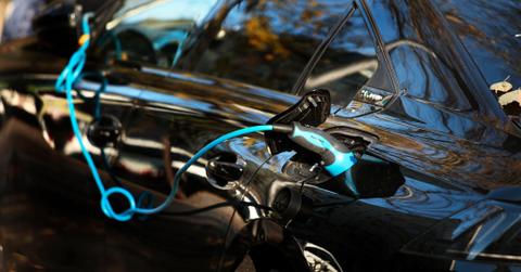 An EV charging at a station