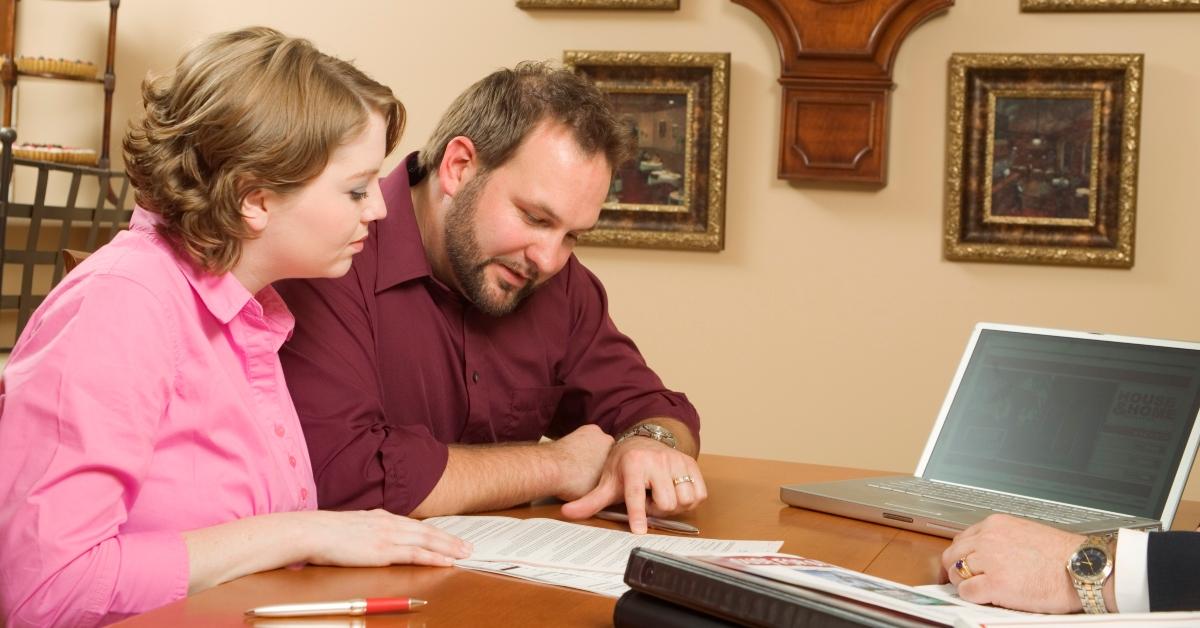 A married couple looking over postnup documents.