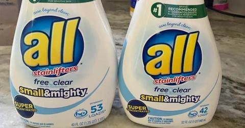A side by side comparison of two containers of All detergent. The new version on the right is smaller.