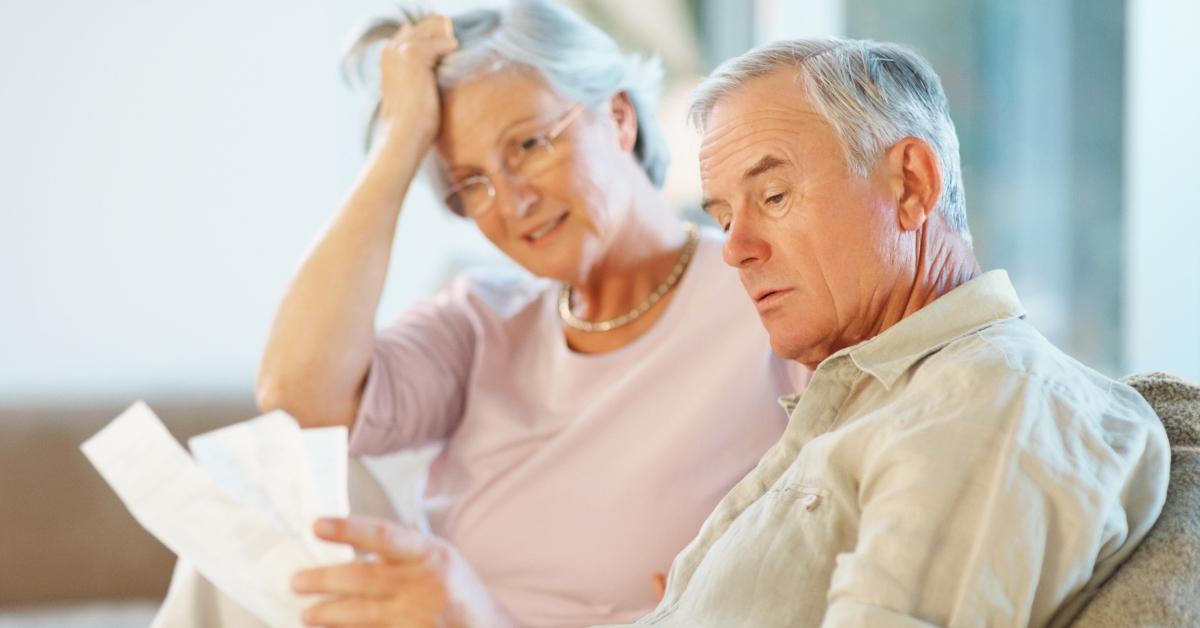 An older couple looking over bills.