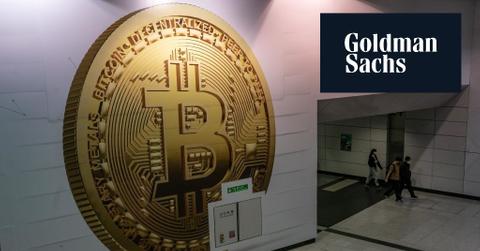 Goldman Sachs logo over Bitcoin sign