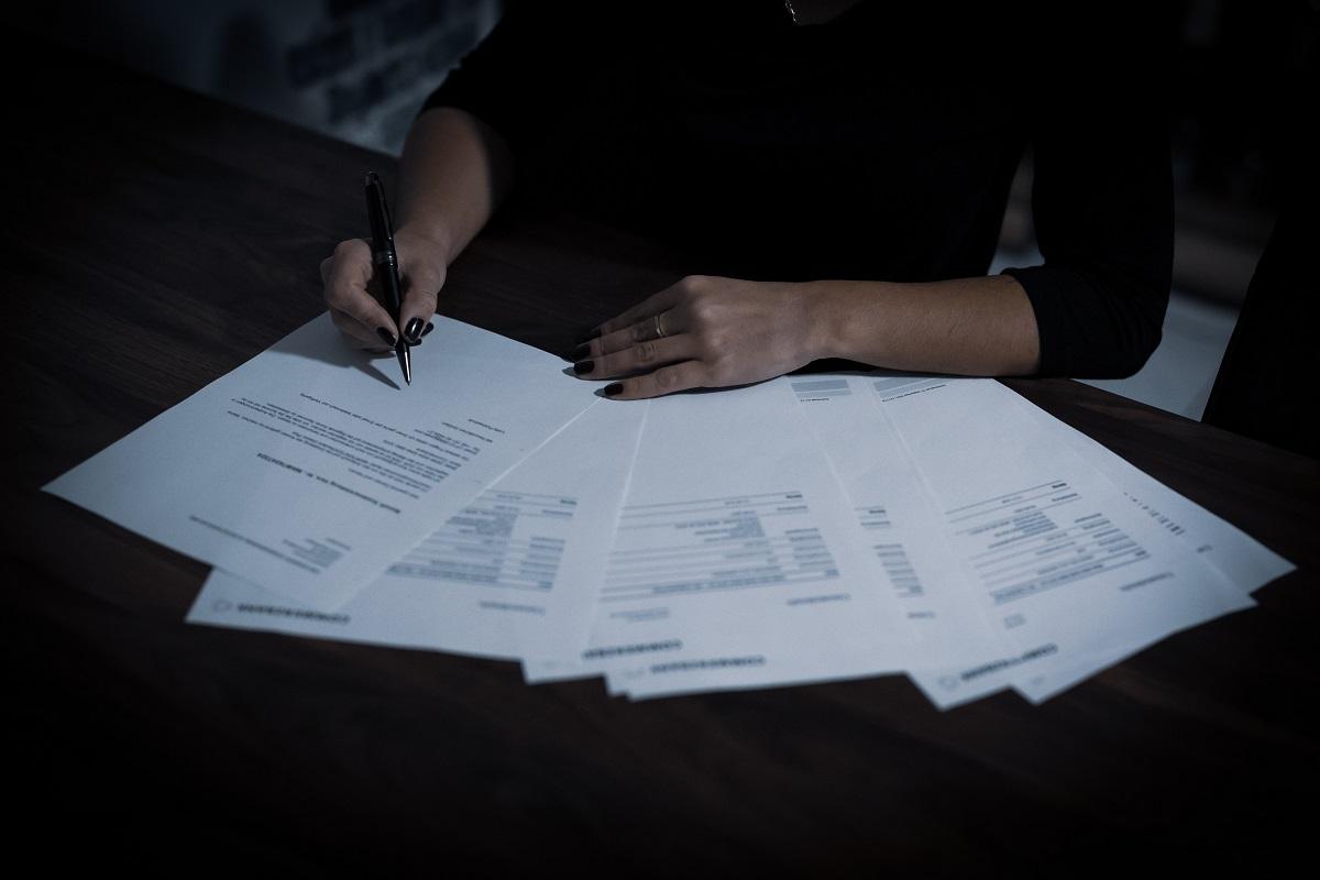 A woman looking at retirement savings plan paperwork