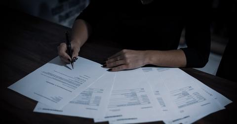 A woman looking at retirement savings plan paperwork