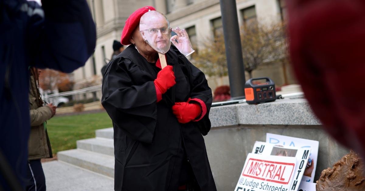  A demonstrator wears a mask of Judge Bruce Schroeder while protesting outside of the Kenosha County Courthouse.