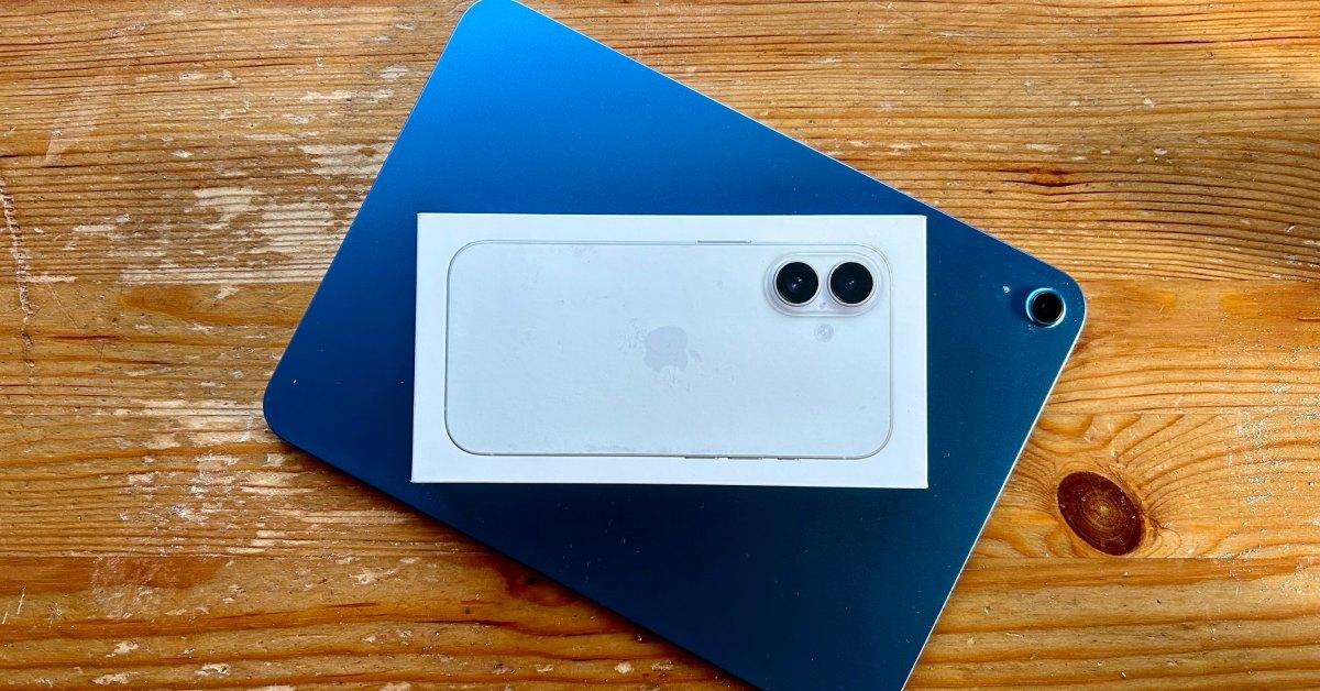 An iPhone 16 in a box on a table.