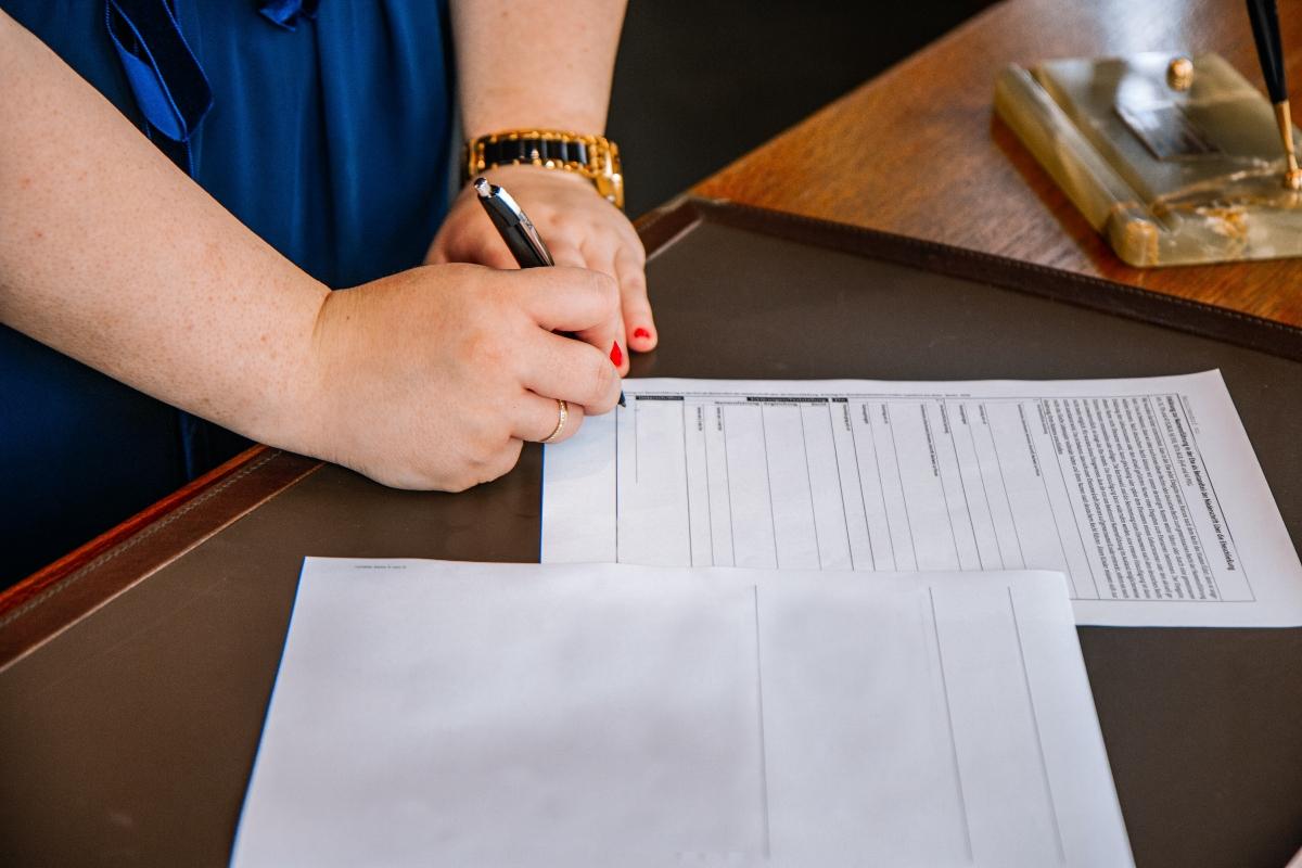 A woman signing documents