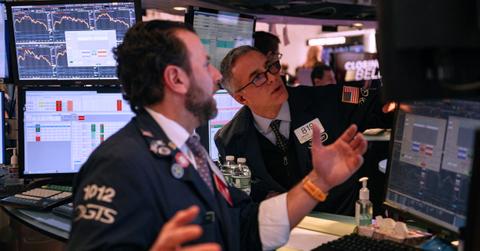 Worried traders look at screen as stocks crash