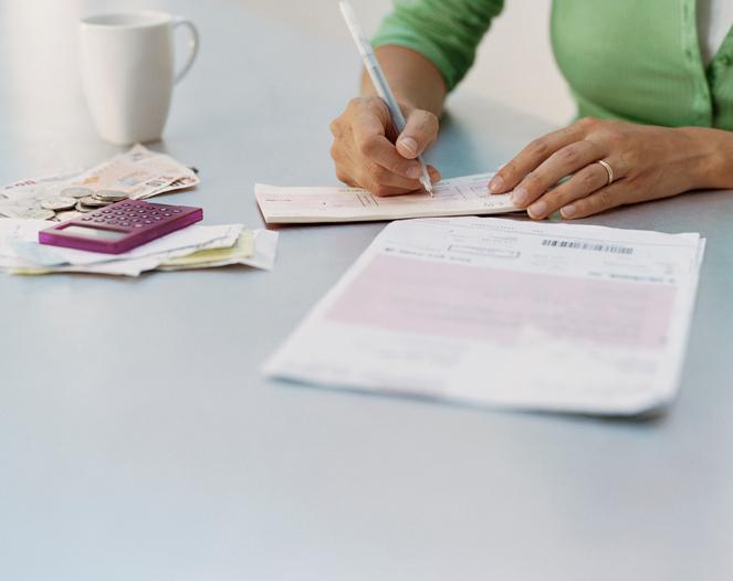 A woman writing a check