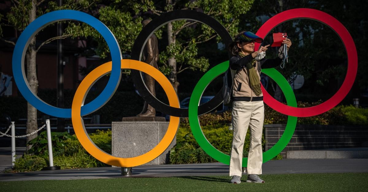 Person taking a photo in front of the Olympic rings